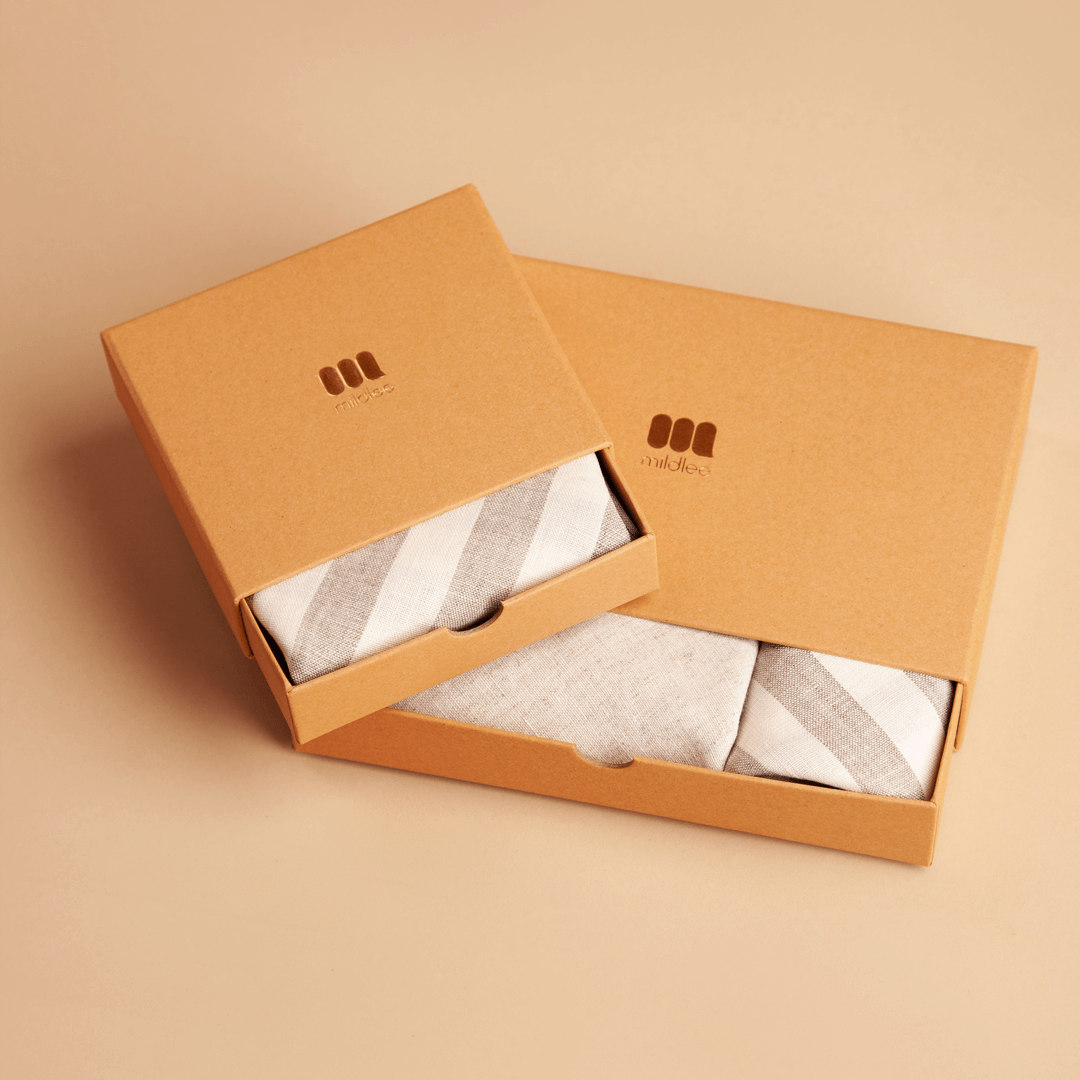 Two Branded Boxes Made of Premium Craft Cardboard in a Beige Shade Containing Linen Bags